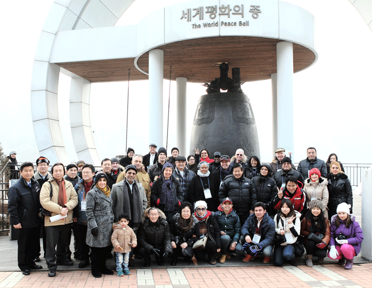 All visiting members of the Seoul Diplomatic Corps pose the camera in front of the World Peace Bell in Hwacheon.