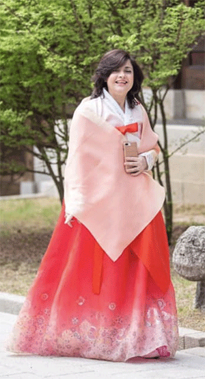 Mrs. Amal Nosseir enjoying wearing Hanbok while touring a palace in Seoul.