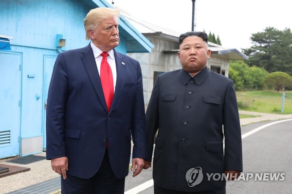 U.S. President Donald Trump (L) stands with North Korean leader Kim Jong-un before they hold talks at the Freedom House on the southern side of the truce village of Panmunjom in the Demilitarized Zone, which separates the two Koreas, on June 30, 2019. (Yonhap)