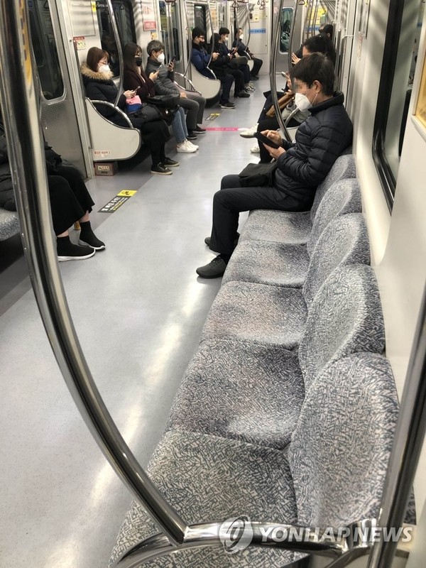 Only a few passengers ride a subway in the southeastern city of Daegu on Feb. 21, 2020, amid the spread of the new coronavirus. (Yonhap)