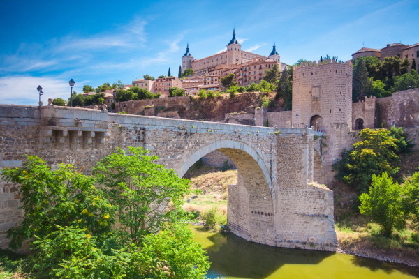 Alcazar and Alcantara Bridge in Toledo, Spain.