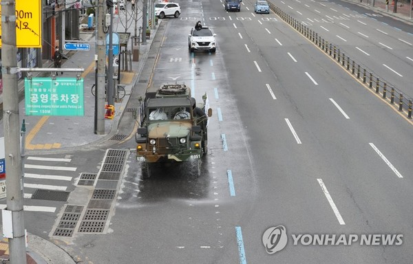 A quarantine vehicle from the Army's 50th Infantry Division disinfects a road in coronavirus-hit Daegu, 300 kilometers southeast of Seoul, on Feb. 27, 2020.