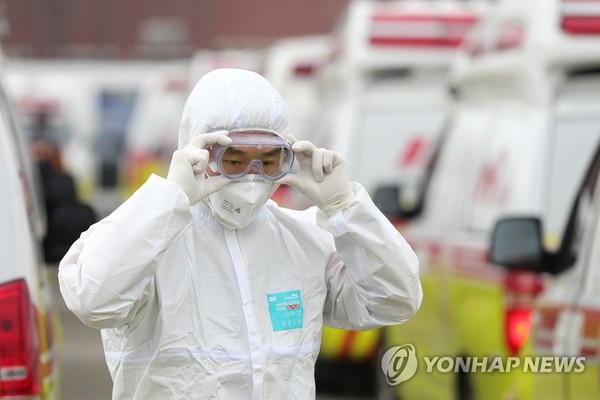 A health worker checks his protective glasses before starting his work in Daegu on March 1, 2020.