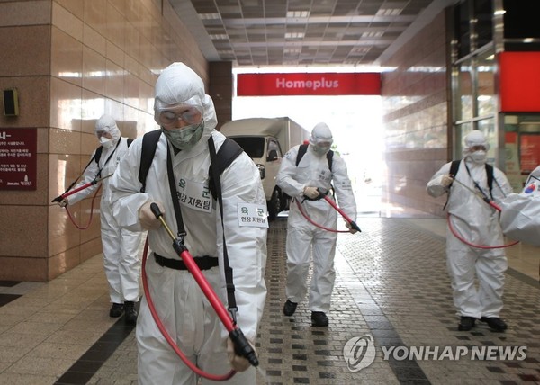 Members of the Army Second Operational Command sterilize a retail outlet in Daegu, the epicenter of South Korea's coronavirus outbreak, on March 5, 2020, in this photo provided by the command.