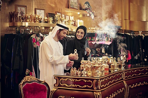 Dubai is the one of the famous markets for perfume. Photo shows people checking perfume at a store.