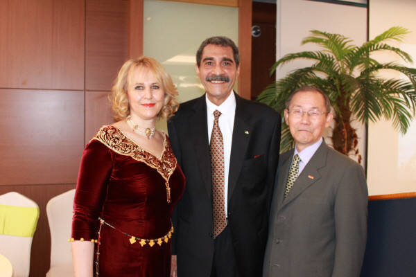Ambassador Derragui Mohammed Elamine of Algeria is flanked on the left by Mrs. Chafika Derragui and Chairman Lee Kyung-sik of The Korea Post media on the right.