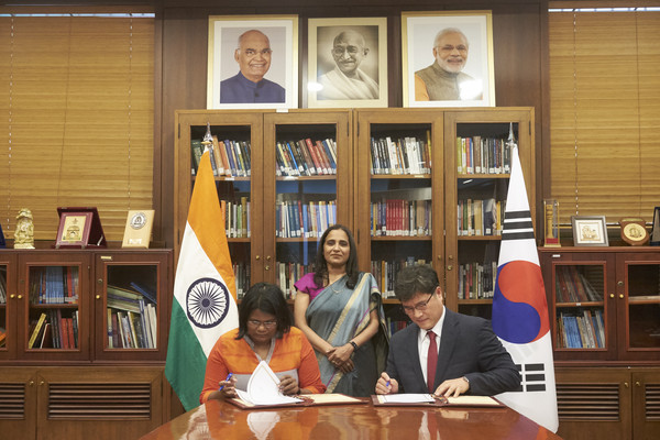 Photo shows Ambassador Abida Islam flanked by the representative of the Indian company on the left and a Korean representative on the right.