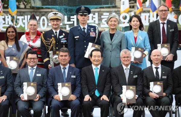 Prime Minister Jung Se-gyun (seated third from right, front row) poses for a commemorative photo with the ambassadors and other representatives of the United Nations participating in the Korean War at a 'Plaque of Peace' awarding ceremony at the Deoksu-gung Palace in Seoul on Jul 7, 2020. Minister of Foreign Affairs Kang Kyung-wha is seen fifth from left in the rear row with Ambassador Sipiria Ramganathan at far left in the same row.