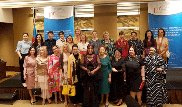 Mrs. Teymurova, the spouse of the Ambassador of Azerbaijan, the host, poses with the spouses of other Ambassadors attending the reception.