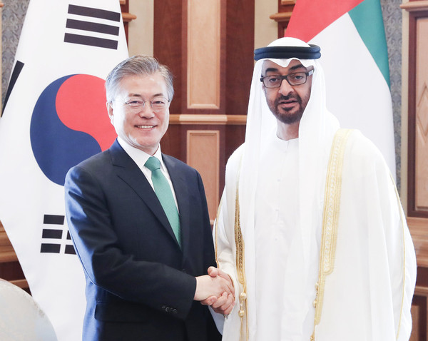 President Moon Jae-in (left) shakes hands with Crown Prince of Abu Dhabi Mohammed bin Zayed Al-Nahyan, at the UAE Presidential Palace in Abu Dhabi.