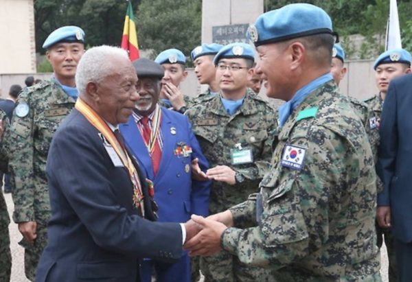 In this photo taken at the Korean War memorial park in Ethiopia on May 27, 2016, a Korean soldier shakes hands with an Ethiopian veteran who fought in the Korean War in the early 1950s.