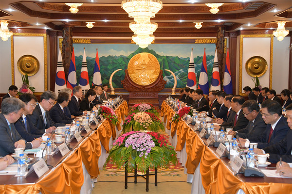 President Moon Jae-in (sixth from left, foreground) and President Bounnhang Vorachith of Laos (seventh from right, foreground) discuss ways to promote relations and cooperation with other leaders of the two countries.