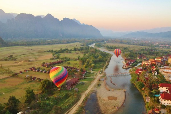 A scenic river town with baloons in Vangvieng District, Vientiane Province.