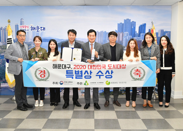 홍순헌 해운대구청장(왼쪽 6번째)이 2020 대한민국 도시대상 특별상을 수상한 다음 직원들과 함께 플래카드를 들고 축하하고 있다