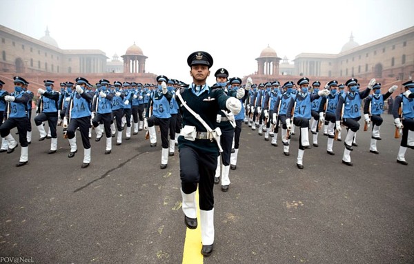 Anothr view of the Republic Day of India parade particiants clad in black uniform under blue shirts with white foot gaiters.