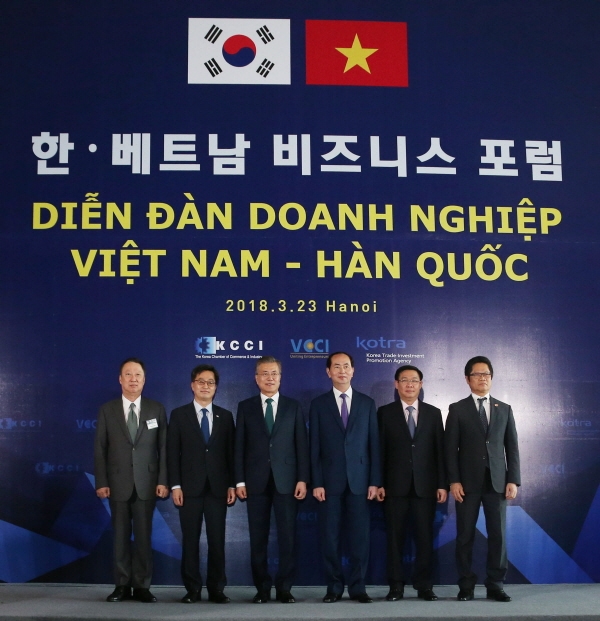 President Moon Jae-in (third from left), the then Vietnamese President Tran Dai Quang (fourth from left) and the then KCCI Chairman Park Yong-man (left), pose for the camera at the Korea-Vietnam Business Forum held in Hanoi on March 23, 2018.