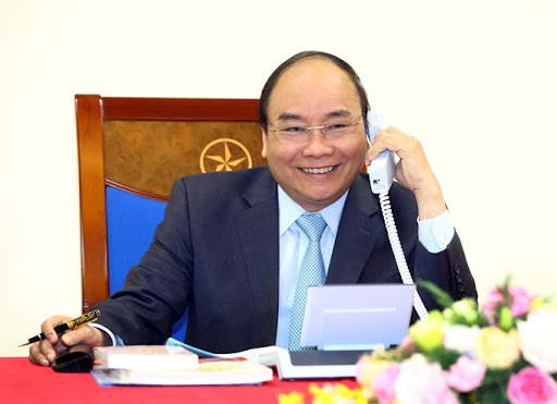 Vietnamese President Nguyen Xuan Phuc is talking on the phone at his office in Vietnam.