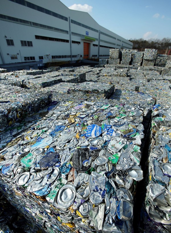 There are tons of cans piled up in front of  Novelis Yeongju Recycling Center