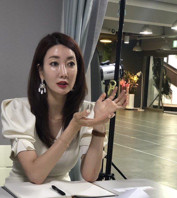 Lee Young-ji, chairperson of Global K Model Association, answers to questions raised by a Korea Post reporter in her office in Seoul. 