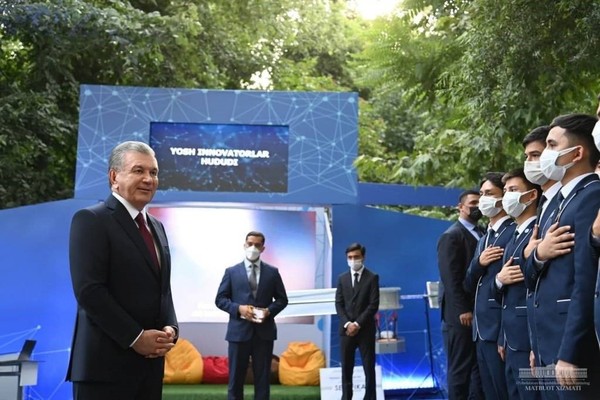 President Mirziyoyev of Uzbekistan (left) speaks at the Youth and Students Forum.