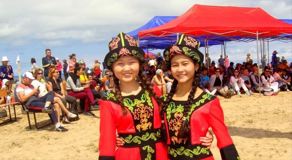 Kyrgyz girls clad in traditional costumes
