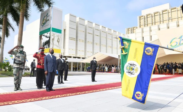 President Bongo of Gabon and members of the Honor Guard of Bongo salute to their National Flag.