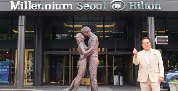 Chairman Hilton Lee poses in front of the Millennium Seoul Hilton hotel in Seoul.