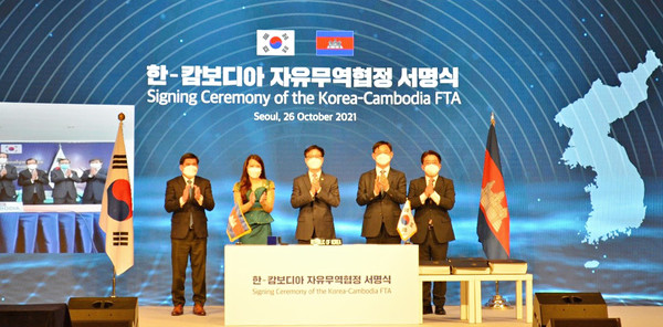 Trade Minister Yeo Han-koo (center) and Ambassador Chring Botum Rangsay of Cambodia in Seoul (second from left) are clapping after signing the Korea-Cambodia FTA, along with other guests at Hotel Lotte in Seoul on Oct. 26.