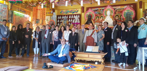 Ambassador Antoine Azzam of Lebanon makes a Buddhist sign with his hands in front of the visiting members of the Diplomatic Corps at the main prayer hall of the Cheonman-sa Templein Ulsan.