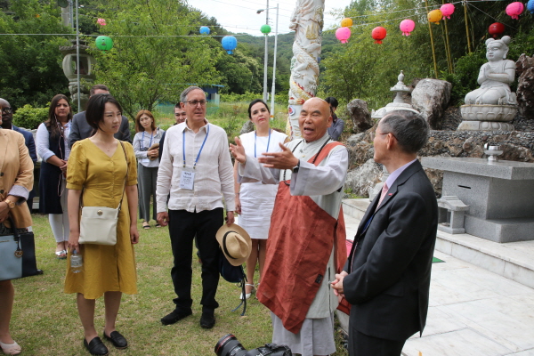 Chief Abbot Park (second from right) introduces the properties of his Temple to the ambassadors. Ambassador and Mrs. Bruno Figueroa of Mexico are seen third and fourth from left.