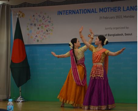 Two women performers of India present a traditional dance.