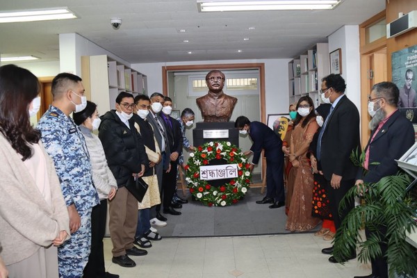 Ambassador Hossain of Bangladesh (on the right of the bust of the Father of the Nation of Bangladesh facing the camera) places a wreath of flowers in front of the statute of the Father of the Nation of Bangladesh on March 7, 2022.