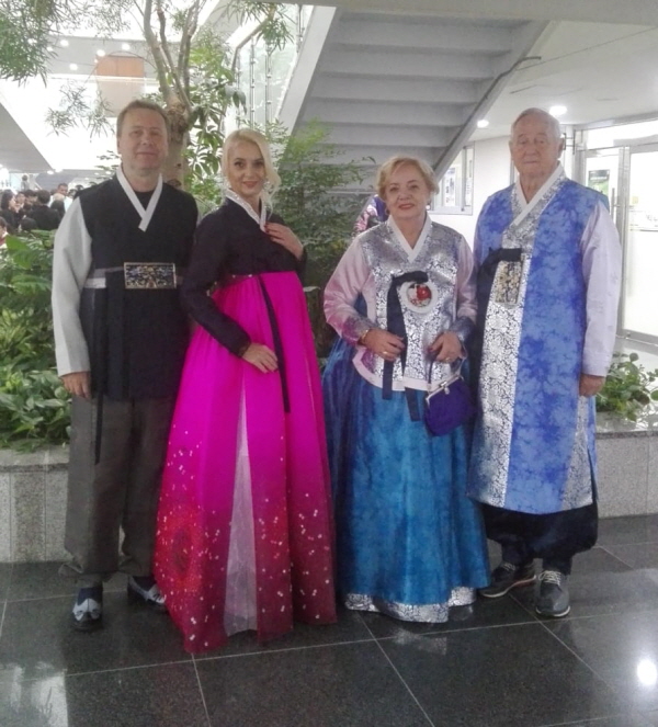 Ambassador Ciompec of Romania in Seoul (left) with his spouse, Madam Kloos, pose with her parents for global costume festival in Korea.
