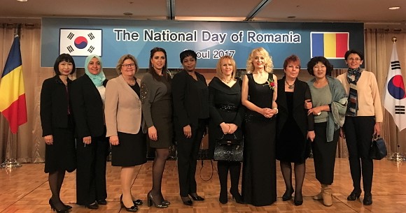 On the occasion of the National Day of Romania, Mrs. Flavia-Athena Kloos (4rh from right), spouse of the Romanian ambassador, poses with other spouses of the ambassadors.