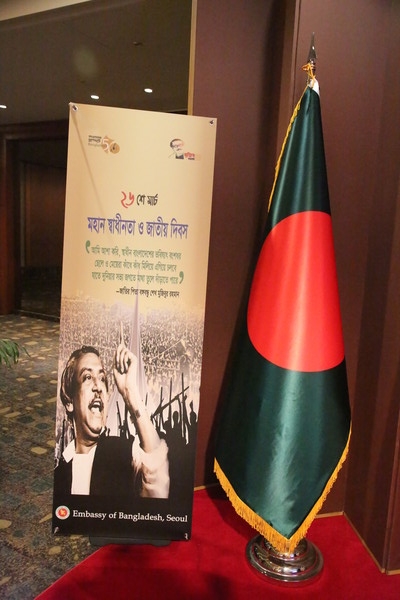 Portrait picture of the National Leader and Father of the Nation of Bangladesh, Bangabandhu Sheikh Mujibur Rahman, shown with the National Flag of the People’s Republic of Bangladesh at the reception venue.