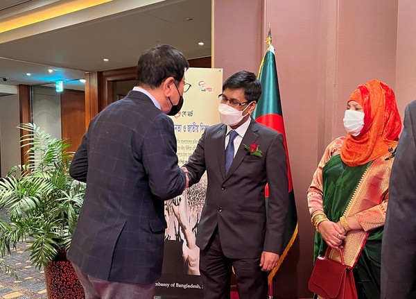 Ambassador Hossain of Bangladesh (center) welcomes Vice-Chairman Song Na-ra of The Korea Post media (left) while Madam looks on at right.