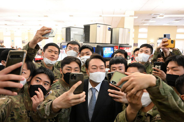President-elect Yoon Suk-yeol takes a 'selfie' with soldiers while visiting the USFK base, Camp Humphreys, in Pyeongtaek on April 7.