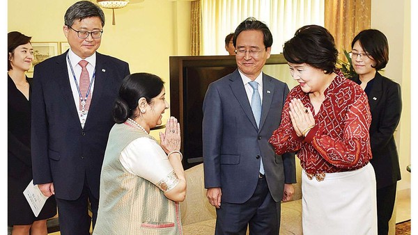 External Affairs Minister Sushma Swaraj (left) greets South Korean First Lady Kim Jung-sook (right) in New Delhi.