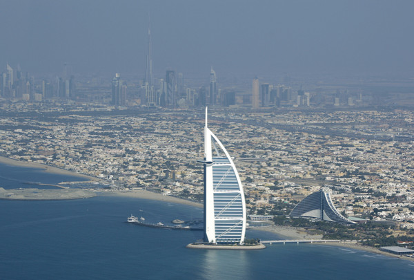 Burj Al Arab, a luxury hotel, foreground, and Burj Dubai, the world's tallest building, in background center, seen from a plane in Dubai, United Arab Emirates, Jan. 3, 2010.