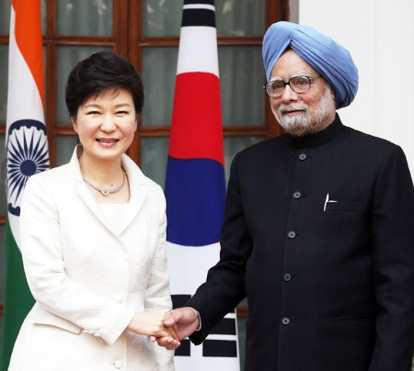 President Park Geun-hye shakes hand with Prime Minister Manmohan Singh of India before holding a summit at the Indian presidential palace in New Delhi, on Jan. 11, 2014.