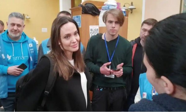 Angelina Jolie (left foreground) listening to volunteers during a visit to Lviv's main railway station. Everyone seems to wish that peace would be restored to the people of Ukrain ASAP.