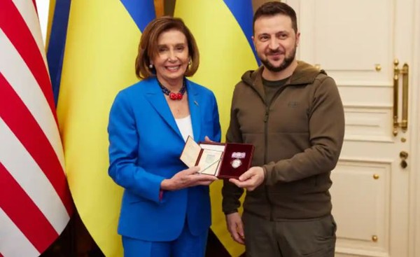 President Volodymyr Zelenskiyof Ukraine (right) awards Speaker Nancy Pelosi with a medal in Kyiv, Ukrtaine.