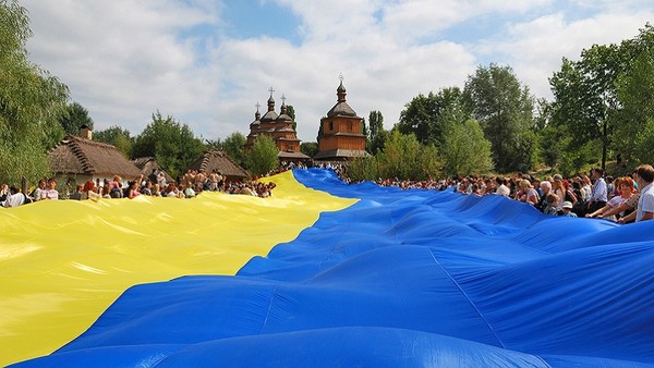 Flag of Ukraine held up by many people of Ukraine who celebrate the Independence Day their country.
