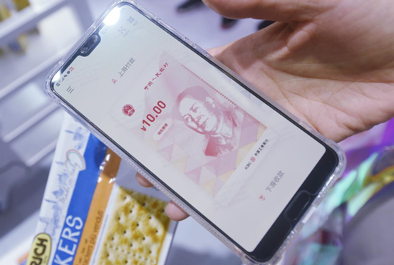 A visitor tries paying with e-CNY at the 2021 World Artificial Intelligence Conference, July 7, 2021. (Photo by Long Wei/People’s Daily Online)