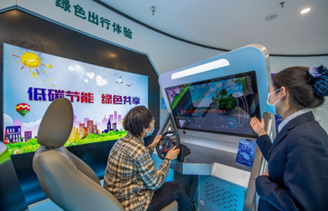 A citizen tries driving a virtual new energy vehicle at a smart energy experience center in Yuncheng city, north China’s Shanxi province, Feb. 24, 2021. (Photo by Xue Jun/People’s Daily Online)