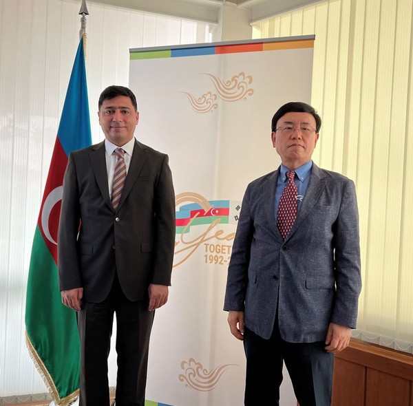 Economic-Commercial Counsellor Vasif Aliyev of Azerbaijan in Seoul (left) poses with Managing Editor Kevin Lee of The Korea Post against the backdrop of the insignia marking the 30th anniversary of diplomatic relations between Korea and Azerbaijan.