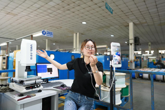 An employee of a cable producer in Nanxun district, Huzhou, east China’s Zhejiang province introduces the company’s products and production lines on a livestream platform, June 16, 2020. (Photo by Zhang Bin/People’s Daily Online)