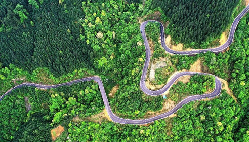 Photo taken on April 25, 2022 shows an aerial view of a country road in Rongjiang county, Qiandongnan Miao and Dong autonomous prefecture, southwest China’s Guizhou province. (Photo by Li Changhua/People’s Daily Online)