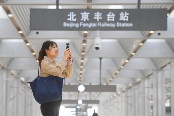 A journalist takes photos at the Beijing Fengtai Railway Station, April 12, 2022. (Photo by Sun Lijun/People's Daily Online)