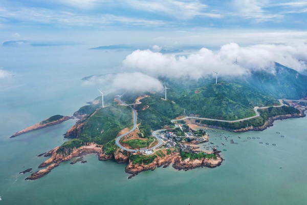 Photo taken on June 15, 2022 shows a country road winding along the coastline in Xiapu county, Ningde city, southeast China's Fujian province. (Photo by Zheng Peiluan/People's Daily Online)